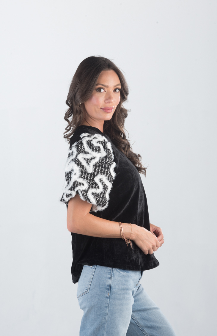 Introducing the Spirit Week Top, a striking black velvet top that brings together bold design and playful details. Featuring puffy sleeves adorned with white feather ruffles, this top is perfect for making a statement and adding a touch of drama to your outfit.
Fabric: Information not provided
Size Guide: Fits True To Size, Model is Wearing a Size S
Available at our boutiques in Chicago, Lake Geneva, and Milwaukee. (Item availability may vary by location.)