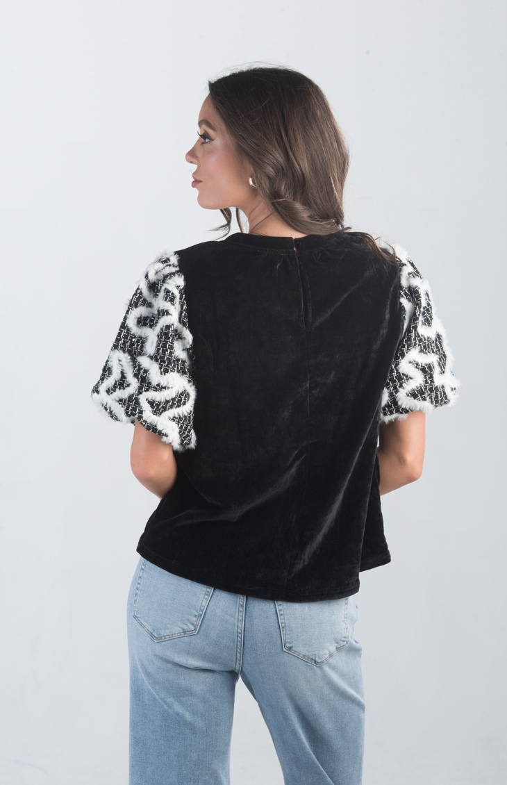 Introducing the Spirit Week Top, a striking black velvet top that brings together bold design and playful details. Featuring puffy sleeves adorned with white feather ruffles, this top is perfect for making a statement and adding a touch of drama to your outfit.
Fabric: Information not provided
Size Guide: Fits True To Size, Model is Wearing a Size S
Available at our boutiques in Chicago, Lake Geneva, and Milwaukee. (Item availability may vary by location.)