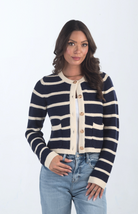 Introducing the Kassidy Striped Cropped Cardigan, a navy and cream striped cardigan that adds a touch of elegance to your wardrobe. This chic cardigan features gold button detailing and a cropped fit, making it perfect for layering or wearing on its own for a polished look.

Fabric: 62% Acrylic, 38% Nylon

Size Guide: Fits True To Size, Model is Wearing a Size S

Available at our boutiques in Chicago, Lake Geneva, and Milwaukee. (Item availability may vary by location.)