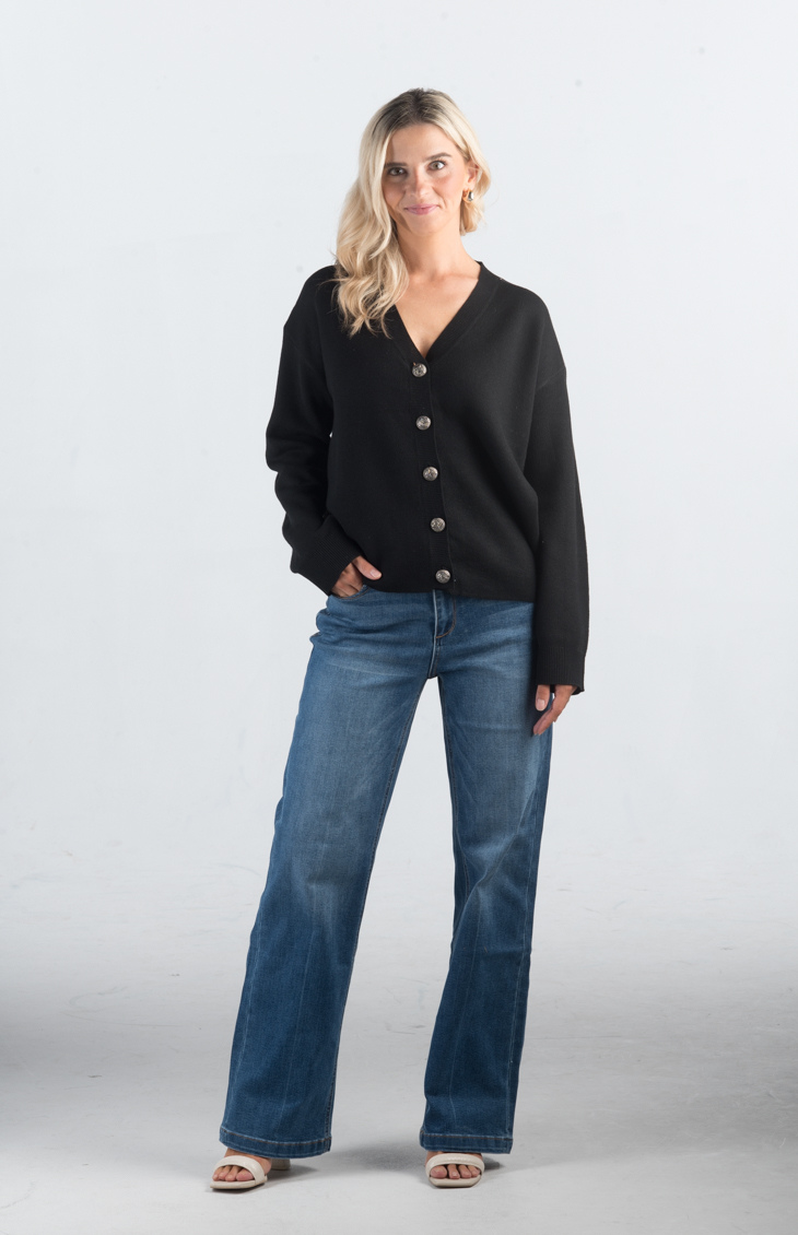 Introducing the It Takes Passion Cardigan, a stylish black button-down cardigan with a twist. The back features a silky material with a beautiful print design, adding an element of surprise and elegance to this cozy piece. Perfect for adding a unique touch to your outfit.

Fabric: 54% Polyester, 20% Acrylic, 20% Nylon, 6% Wool

Size Guide: Fits True To Size, Model is Wearing a Size S

Available at our boutiques in Chicago, Lake Geneva, and Milwaukee. (Item availability may vary by location.)