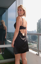 Black mini dress with white polka dots, lace trim, and a back cutout from our boutique in Chicago, Lake Geneva, and Milwaukee. Perfect for a flirty and elegant look.