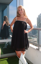 Black babydoll dress with white straps from our boutique in Chicago, Lake Geneva, and Milwaukee. Perfect for a stylish and comfortable look.