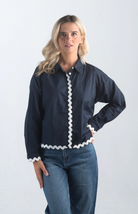 Introducing the Polly Blouse, a stylish navy blouse featuring playful white squiggly stripes. This button-down, collared blouse with long sleeves offers a timeless look, perfect for both casual and professional settings.

Fabric: 100% Cotton

Size Guide: Fits True To Size, Model is Wearing a Size S

Available at our boutiques in Chicago, Lake Geneva, and Milwaukee. (Item availability may vary by location.)