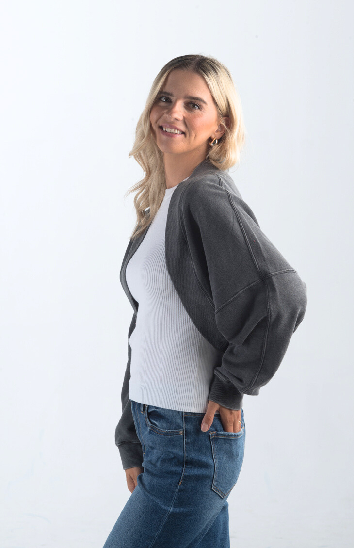 Introducing the Perfect Weather Shrug, a soft and comfortable bolero that's perfect for layering. This long-sleeved shrug in a versatile charcoal color adds warmth and style to any outfit, making it an essential piece for those in-between weather days.

Fabric: Information not provided

Size Guide: Fits True To Size, Model is Wearing a Size S

Available at our boutiques in Chicago, Lake Geneva, and Milwaukee. (Item availability may vary by location.)