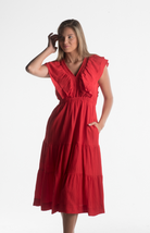 Red midi dress with ruffle sleeves and V-neckline from our boutique in Chicago, Lake Geneva, and Milwaukee. Perfect for a chic and elegant look.