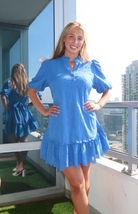 Charming blue eyelet dress with puff sleeves and a ruffled hem, perfect for a cute and casual look from our boutique in Chicago, Lake Geneva, and Milwaukee.