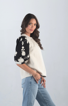 Introducing the Together at Last Top, a beautifully textured ivory top that effortlessly blends elegance with style. Featuring black and white floral designs on the puffy sleeves, this top adds a sophisticated touch to any outfit, making it perfect for both casual and special occasions.

Fabric: Self: 100% Polyester; Lining: 100% Cotton

Size Guide: Fits True To Size, Model is Wearing a Size S

Available at our boutiques in Chicago, Lake Geneva, and Milwaukee. (Item availability may vary by location.)