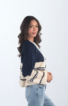 Introducing the Different Views Sweater, a luxurious midnight blue and cream knit cardigan that offers both comfort and style. Made from soft materials, this sweater is perfect for layering, providing warmth and elegance for any outfit.

Fabric: 95% Acrylic, 5% Nylon

Size Guide: Fits True To Size, Model is Wearing a Size S

Available at our boutiques in Chicago, Lake Geneva, and Milwaukee. (Item availability may vary by location.)