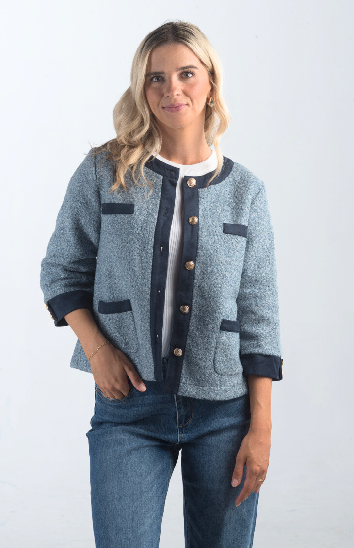 Introducing the A Little Dramatic Cardigan, a chic slate blue light jacket that combines style with subtle drama. Featuring gold button detailing and navy accents on the hem, this cardigan is perfect for adding a sophisticated touch to any outfit.

Fabric: Self: 50% Polyester, 50% Rayon; Contrast: 92% Polyester, 8% Spandex

Size Guide: Fits True To Size, Model is Wearing a Size S

Available at our boutiques in Chicago, Lake Geneva, and Milwaukee. (Item availability may vary by location.)