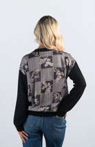 Introducing the It Takes Passion Cardigan, a stylish black button-down cardigan with a twist. The back features a silky material with a beautiful print design, adding an element of surprise and elegance to this cozy piece. Perfect for adding a unique touch to your outfit.

Fabric: 54% Polyester, 20% Acrylic, 20% Nylon, 6% Wool

Size Guide: Fits True To Size, Model is Wearing a Size S

Available at our boutiques in Chicago, Lake Geneva, and Milwaukee. (Item availability may vary by location.)