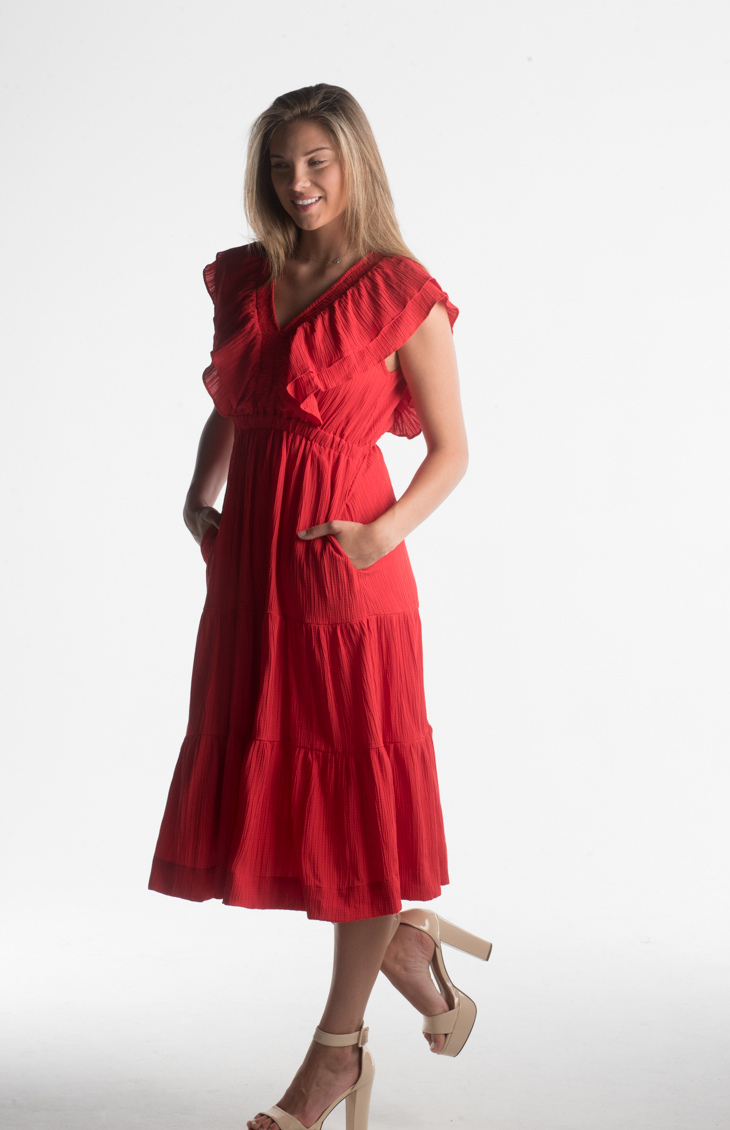 Red midi dress with ruffle sleeves and V-neckline from our boutique in Chicago, Lake Geneva, and Milwaukee. Perfect for a chic and elegant look.