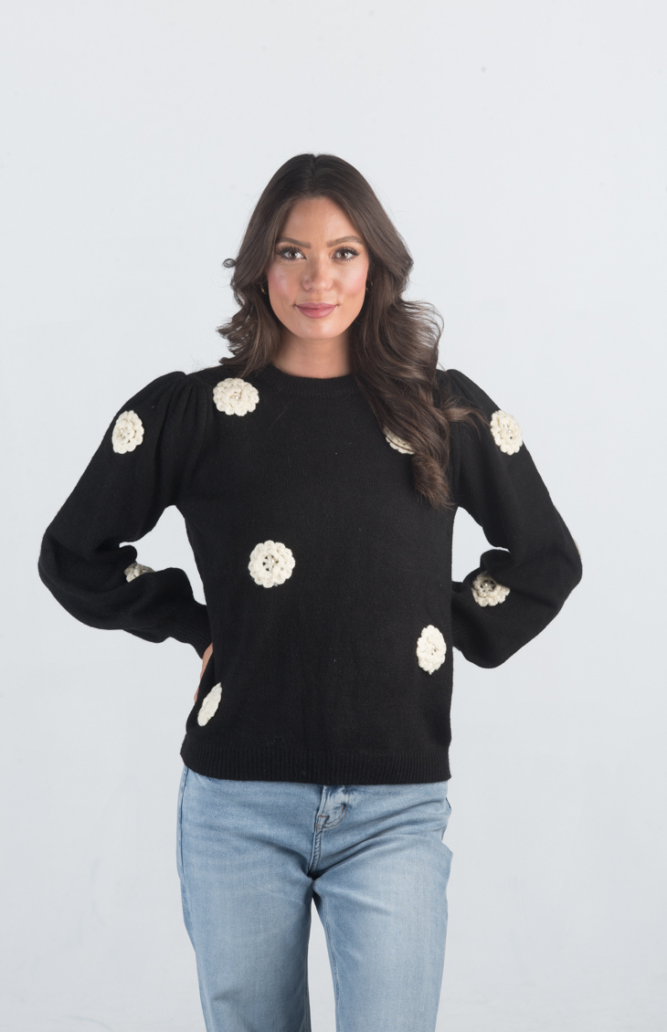 Introducing the Be Different Sweater, a cozy black sweater adorned with white flowers, perfect for adding a touch of charm to your wardrobe. With its soft material, long sleeves, and crew neckline, this sweater offers both comfort and style, making it ideal for any casual outing.

Fabric: 52% Acrylic, 28% Nylon, 20% Polyester

Size Guide: Fits True To Size, Model is Wearing a Size S

Available at our boutiques in Chicago, Lake Geneva, and Milwaukee. (Item availability may vary by location.)