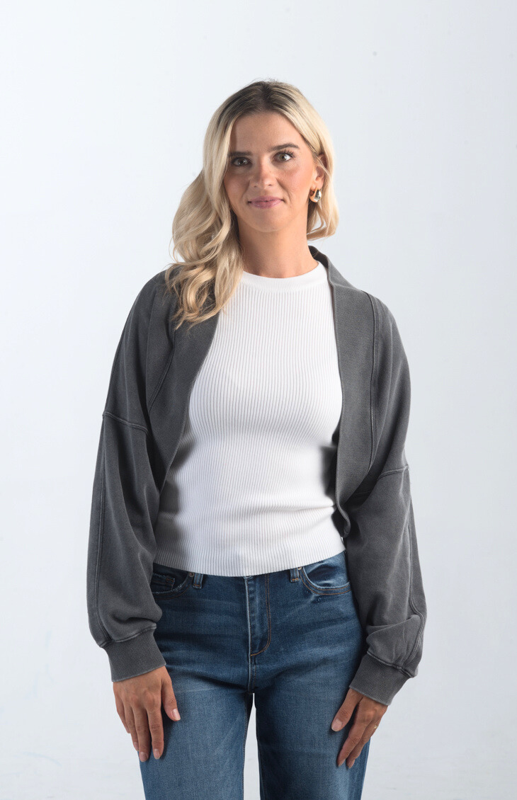 Introducing the Perfect Weather Shrug, a soft and comfortable bolero that's perfect for layering. This long-sleeved shrug in a versatile charcoal color adds warmth and style to any outfit, making it an essential piece for those in-between weather days.

Fabric: Information not provided

Size Guide: Fits True To Size, Model is Wearing a Size S

Available at our boutiques in Chicago, Lake Geneva, and Milwaukee. (Item availability may vary by location.)