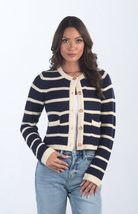 Introducing the Kassidy Striped Cropped Cardigan, a navy and cream striped cardigan that adds a touch of elegance to your wardrobe. This chic cardigan features gold button detailing and a cropped fit, making it perfect for layering or wearing on its own for a polished look.

Fabric: 62% Acrylic, 38% Nylon

Size Guide: Fits True To Size, Model is Wearing a Size S

Available at our boutiques in Chicago, Lake Geneva, and Milwaukee. (Item availability may vary by location.)