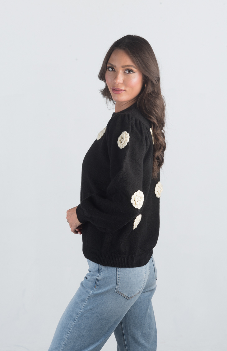 Introducing the Be Different Sweater, a cozy black sweater adorned with white flowers, perfect for adding a touch of charm to your wardrobe. With its soft material, long sleeves, and crew neckline, this sweater offers both comfort and style, making it ideal for any casual outing.

Fabric: 52% Acrylic, 28% Nylon, 20% Polyester

Size Guide: Fits True To Size, Model is Wearing a Size S

Available at our boutiques in Chicago, Lake Geneva, and Milwaukee. (Item availability may vary by location.)