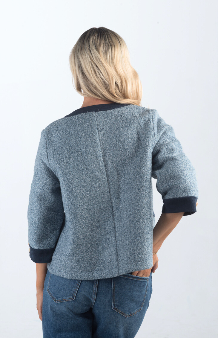 Introducing the A Little Dramatic Cardigan, a chic slate blue light jacket that combines style with subtle drama. Featuring gold button detailing and navy accents on the hem, this cardigan is perfect for adding a sophisticated touch to any outfit.

Fabric: Self: 50% Polyester, 50% Rayon; Contrast: 92% Polyester, 8% Spandex

Size Guide: Fits True To Size, Model is Wearing a Size S

Available at our boutiques in Chicago, Lake Geneva, and Milwaukee. (Item availability may vary by location.)