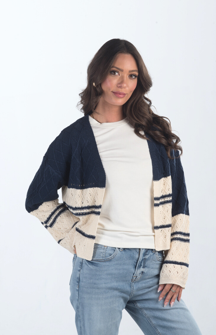 Introducing the Different Views Sweater, a luxurious midnight blue and cream knit cardigan that offers both comfort and style. Made from soft materials, this sweater is perfect for layering, providing warmth and elegance for any outfit.

Fabric: 95% Acrylic, 5% Nylon

Size Guide: Fits True To Size, Model is Wearing a Size S

Available at our boutiques in Chicago, Lake Geneva, and Milwaukee. (Item availability may vary by location.)