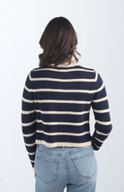 Introducing the Kassidy Striped Cropped Cardigan, a navy and cream striped cardigan that adds a touch of elegance to your wardrobe. This chic cardigan features gold button detailing and a cropped fit, making it perfect for layering or wearing on its own for a polished look.

Fabric: 62% Acrylic, 38% Nylon

Size Guide: Fits True To Size, Model is Wearing a Size S

Available at our boutiques in Chicago, Lake Geneva, and Milwaukee. (Item availability may vary by location.)