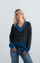 Introducing the Double or Nothing Sweater, a striking black and blue striped sweater that effortlessly combines bold design with elegance. Featuring a v-neckline and gold button detailing on the sleeves, this long-sleeved sweater is perfect for adding a touch of sophistication to your wardrobe.

Fabric: 54% Polyester, 20% Acrylic, 20% Nylon, 6% Wool

Size Guide: Fits True To Size, Model is Wearing a Size S

Available at our boutiques in Chicago, Lake Geneva, and Milwaukee. (Item availability may vary by loc