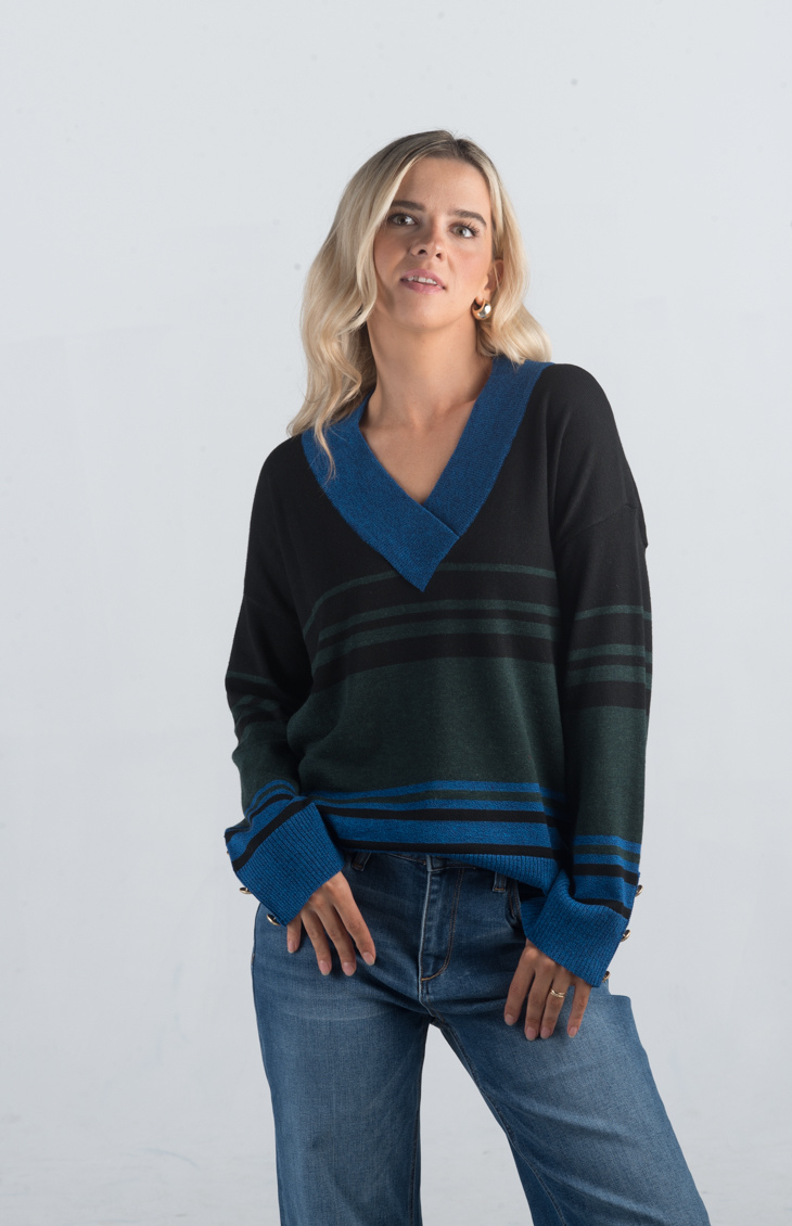 Introducing the Double or Nothing Sweater, a striking black and blue striped sweater that effortlessly combines bold design with elegance. Featuring a v-neckline and gold button detailing on the sleeves, this long-sleeved sweater is perfect for adding a touch of sophistication to your wardrobe.

Fabric: 54% Polyester, 20% Acrylic, 20% Nylon, 6% Wool

Size Guide: Fits True To Size, Model is Wearing a Size S

Available at our boutiques in Chicago, Lake Geneva, and Milwaukee. (Item availability may vary by loc