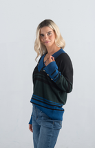 Introducing the Double or Nothing Sweater, a striking black and blue striped sweater that effortlessly combines bold design with elegance. Featuring a v-neckline and gold button detailing on the sleeves, this long-sleeved sweater is perfect for adding a touch of sophistication to your wardrobe.

Fabric: 54% Polyester, 20% Acrylic, 20% Nylon, 6% Wool

Size Guide: Fits True To Size, Model is Wearing a Size S

Available at our boutiques in Chicago, Lake Geneva, and Milwaukee. (Item availability may vary by loc