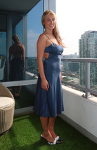 Elegant blue midi dress with thin straps and a flattering silhouette from our boutique in Chicago, Lake Geneva, and Milwaukee. Ideal for a chic and sophisticated look.