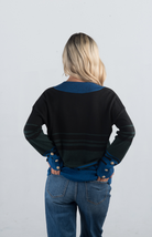 Introducing the Double or Nothing Sweater, a striking black and blue striped sweater that effortlessly combines bold design with elegance. Featuring a v-neckline and gold button detailing on the sleeves, this long-sleeved sweater is perfect for adding a touch of sophistication to your wardrobe.

Fabric: 54% Polyester, 20% Acrylic, 20% Nylon, 6% Wool

Size Guide: Fits True To Size, Model is Wearing a Size S

Available at our boutiques in Chicago, Lake Geneva, and Milwaukee. (Item availability may vary by loc