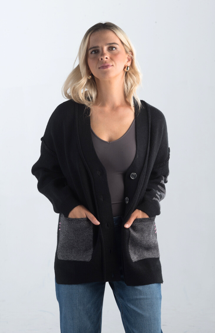 Introducing the Vital Moment Cardigan, a chic black and gray cardigan featuring unique "Dreamer" text on the sleeves. With front pockets and a button-up design, this cardigan combines comfort and style, making it a versatile addition to your wardrobe.

Fabric: 40% Acrylic, 30% Polyester, 30% PBT

Size Guide: Fits True To Size, Model is Wearing a Size S

Available at our boutiques in Chicago, Lake Geneva, and Milwaukee. (Item availability may vary by location.)