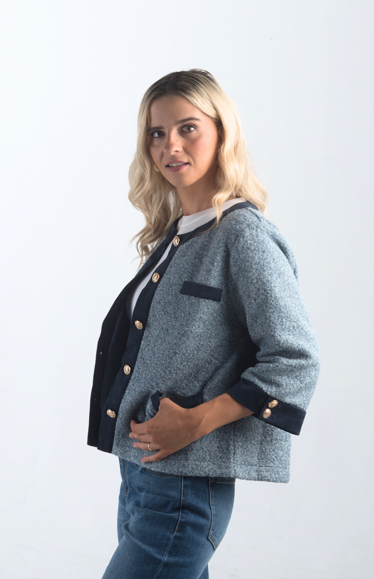 Introducing the A Little Dramatic Cardigan, a chic slate blue light jacket that combines style with subtle drama. Featuring gold button detailing and navy accents on the hem, this cardigan is perfect for adding a sophisticated touch to any outfit.

Fabric: Self: 50% Polyester, 50% Rayon; Contrast: 92% Polyester, 8% Spandex

Size Guide: Fits True To Size, Model is Wearing a Size S

Available at our boutiques in Chicago, Lake Geneva, and Milwaukee. (Item availability may vary by location.)