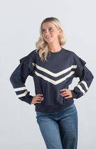 Introducing the Darlene Top, a chic navy sweater featuring white asymmetrical stripes and a delicate ruffle detail on the long sleeves. This unique design adds a touch of elegance and flair to your wardrobe, making it perfect for both casual and sophisticated looks.

Fabric: 85% Cotton, 15% Polyester

Size Guide: Fits True To Size, Model is Wearing a Size S

Available at our boutiques in Chicago, Lake Geneva, and Milwaukee. (Item availability may vary by location.)