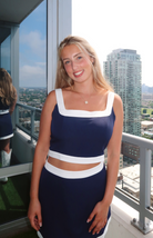 Dallas Cowboys-inspired matching set with a blue crop top and skirt featuring white trim from our boutique in Chicago, Lake Geneva, and Milwaukee. Perfect for a sporty and stylish look.