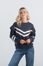 Introducing the Darlene Top, a chic navy sweater featuring white asymmetrical stripes and a delicate ruffle detail on the long sleeves. This unique design adds a touch of elegance and flair to your wardrobe, making it perfect for both casual and sophisticated looks.

Fabric: 85% Cotton, 15% Polyester

Size Guide: Fits True To Size, Model is Wearing a Size S

Available at our boutiques in Chicago, Lake Geneva, and Milwaukee. (Item availability may vary by location.)