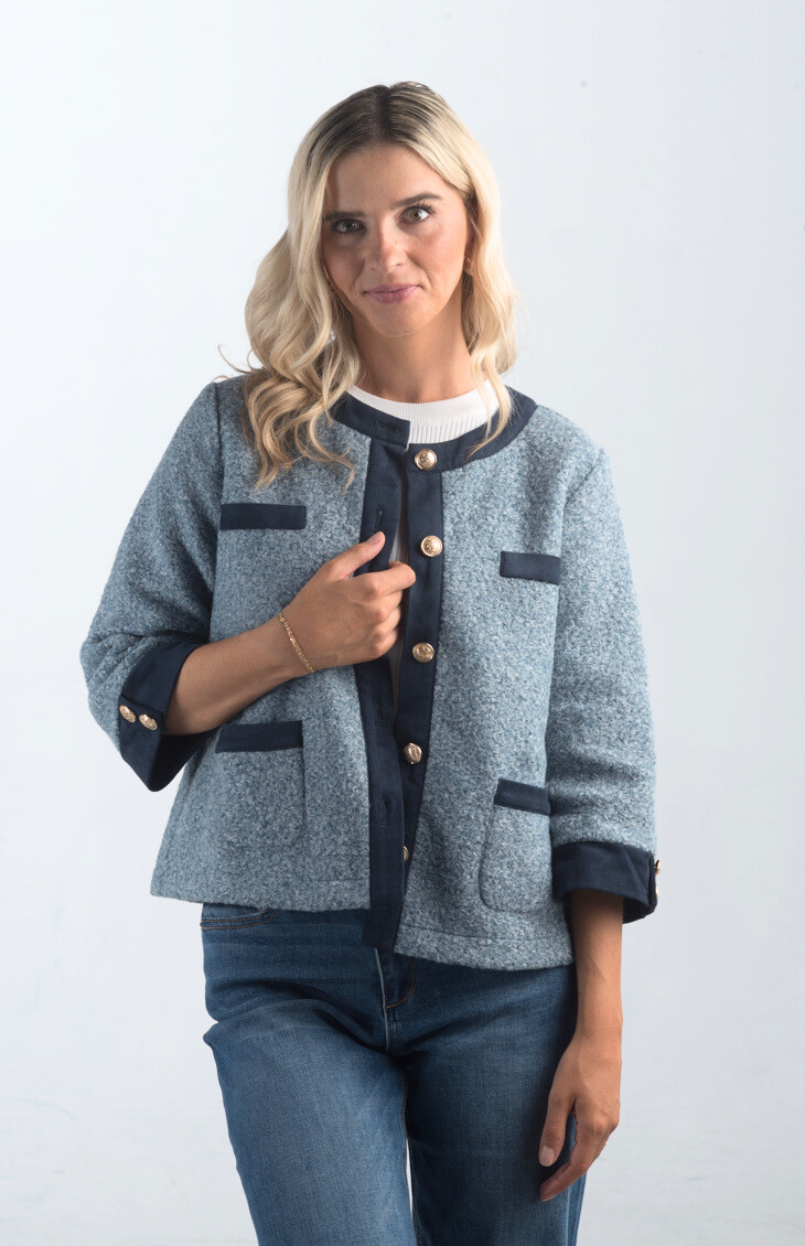 Introducing the A Little Dramatic Cardigan, a chic slate blue light jacket that combines style with subtle drama. Featuring gold button detailing and navy accents on the hem, this cardigan is perfect for adding a sophisticated touch to any outfit.

Fabric: Self: 50% Polyester, 50% Rayon; Contrast: 92% Polyester, 8% Spandex

Size Guide: Fits True To Size, Model is Wearing a Size S

Available at our boutiques in Chicago, Lake Geneva, and Milwaukee. (Item availability may vary by location.)